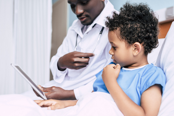 médico afroamericano y paciente con tableta
 - Foto, Imagen