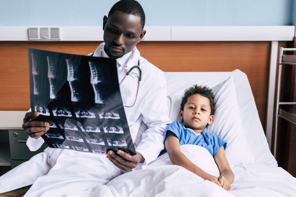 medico afroamericano e paziente con immagine a raggi X
 - Foto, immagini