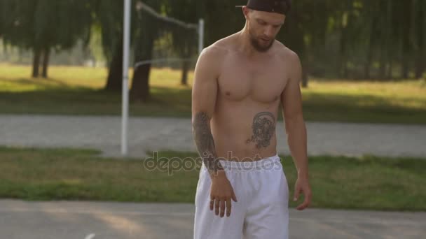 man playing basketball on the basketball court, close-up - Materiał filmowy, wideo
