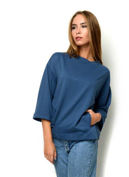 Young happy beautiful woman posing in new fashion blue jeans and pullover  - Φωτογραφία, εικόνα