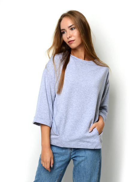 woman posing in new fashion blue jeans and pullover with text copy space - Foto, afbeelding