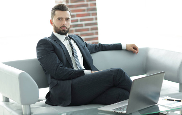 Portrait of a successful businessman sitting in the office lobby. - Фото, изображение