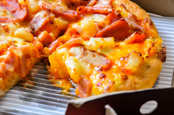 Sluiten van pizza 's met verschillende toppings en kaas in karton nemen dozen met open deksel - Foto, afbeelding