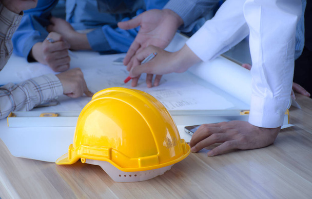 Safety helmet placed on a meeting table engineering team. ,Engineering concept. - 写真・画像