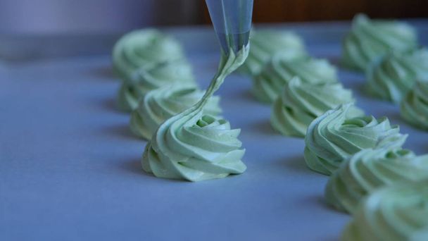Nyomja össze a tejszínt, a zöld cupcake, closeup kitöltése - Fotó, kép