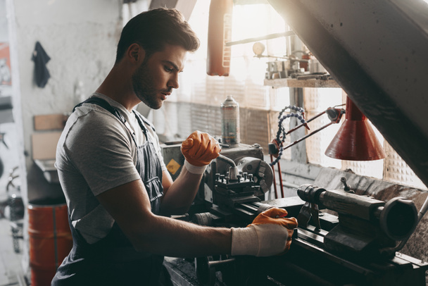 handsome repairman in workshop - Photo, Image