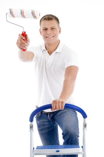 Young man holding paint roller - Foto, imagen