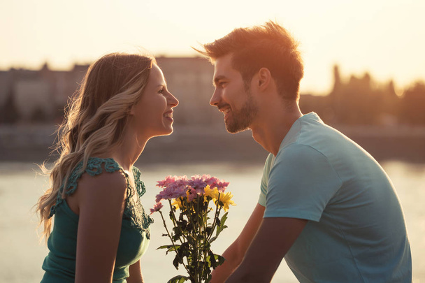 Man giving flowers to his girlfriend - Photo, Image