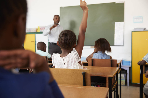 Kids with hands up in school class - Φωτογραφία, εικόνα