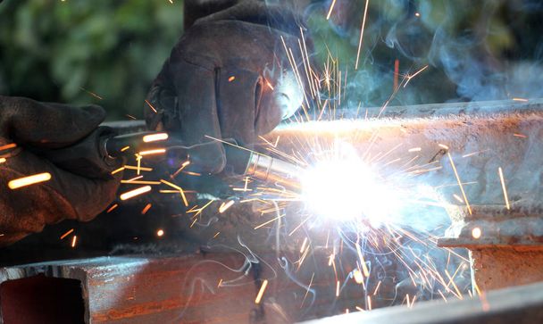 Welding work.sparks and smoke of a welding work - Photo, Image