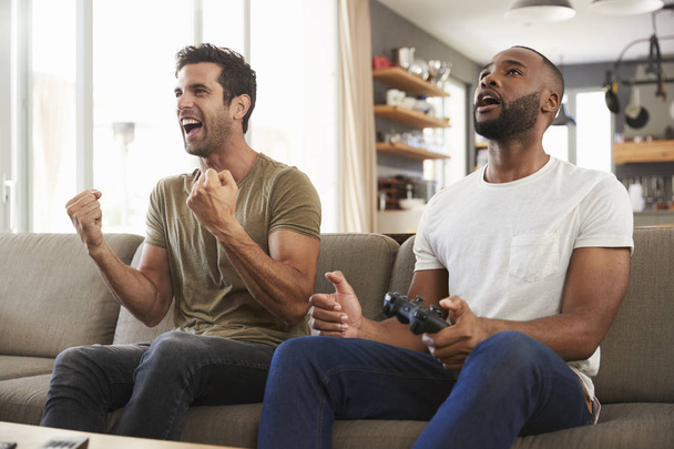 Male Friends Playing Video Game - 写真・画像