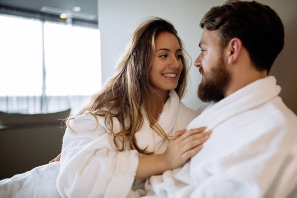 Couple wearing bathrobes in hotel - Фото, изображение