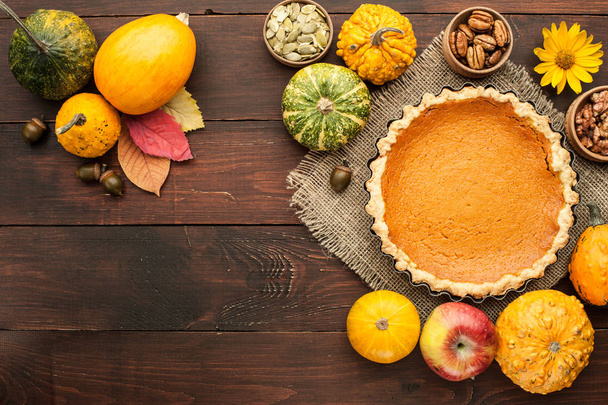 pumpkin homemade pie at wooden background arranged with food ing - Foto, Imagem