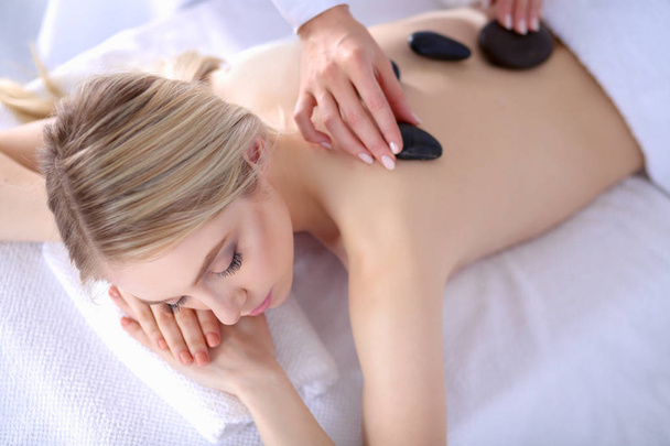 Young woman lying on a massage table,relaxing with eyes closed. Woman. Spa salon - Фото, зображення