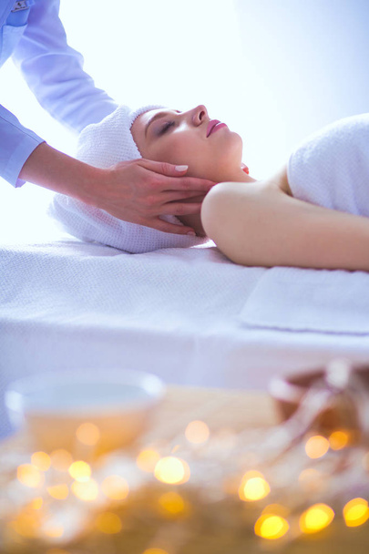 Young woman lying on a massage table,relaxing with eyes closed. Woman. Spa salon - Foto, Imagen