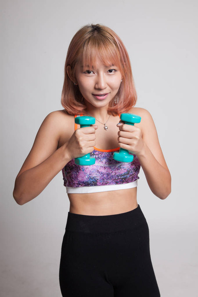 Beautiful Asian healthy girl exercise with dumbbell. - Photo, Image
