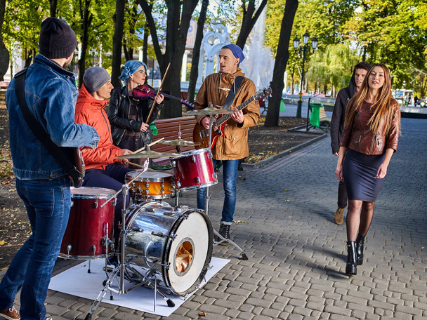 Festival music band. Friends playing on instruments city autumn park. - Photo, Image