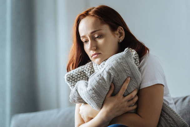 Sad depressed woman hugging a cushion - Photo, Image