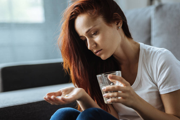Cheerless attractive woman holding a glass of water - Photo, Image