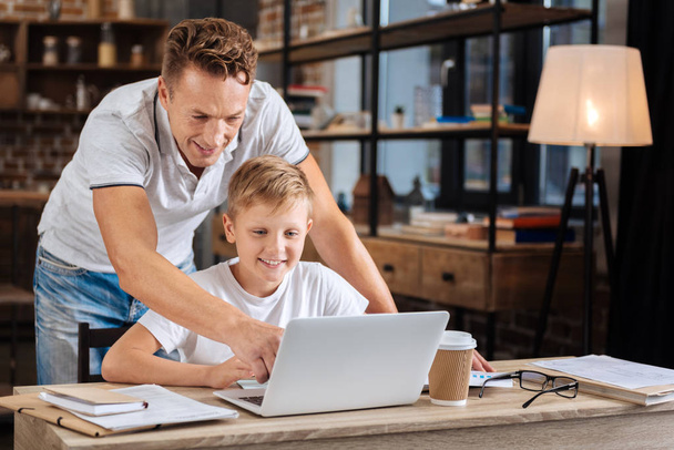 Cheerful father choosing data for project together with son - Фото, зображення