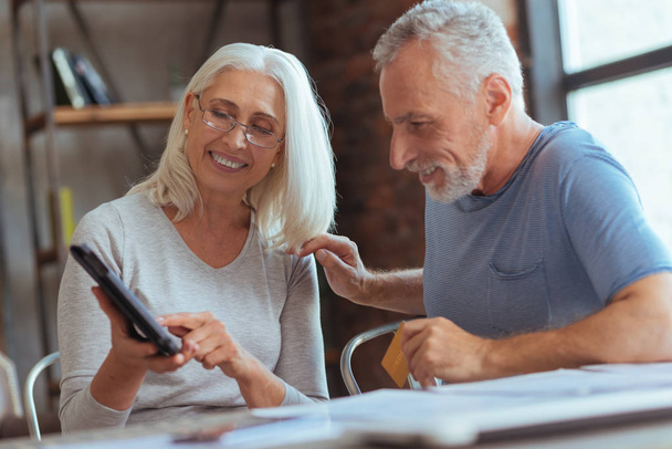 Positive aged couple purchasing online - Photo, image