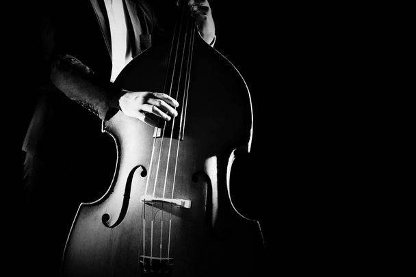 Double bass player playing contrabass musical instrument - Foto, afbeelding