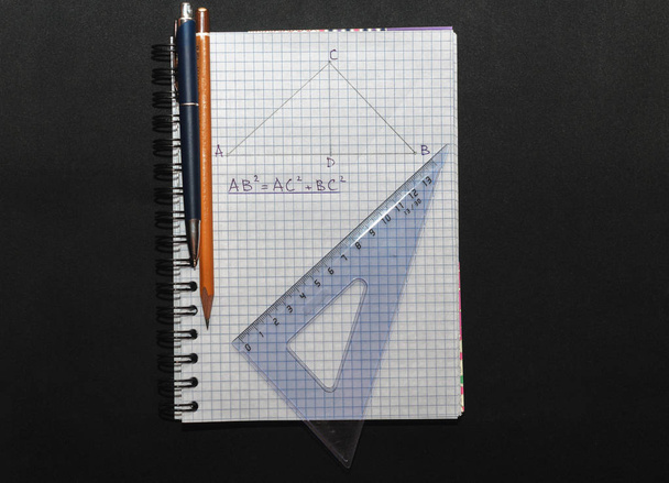 Page with formulas and the Pythagorean theorem with pen - Фото, изображение