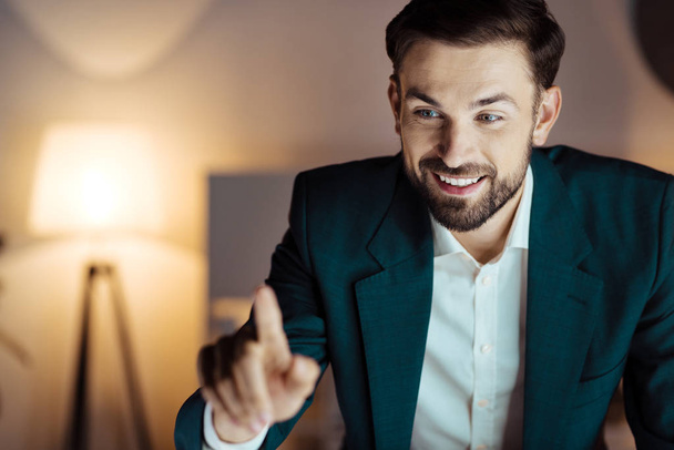 Positive delighted man looking at his finger - Photo, Image