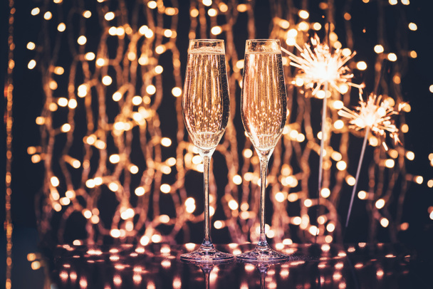 glazen champagne en wonderkaarsen - Foto, afbeelding