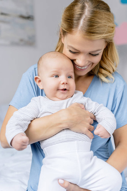mother holding infant - Photo, Image