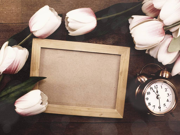 wooden photo frames space background decorate with artificial tulip flowers - 写真・画像