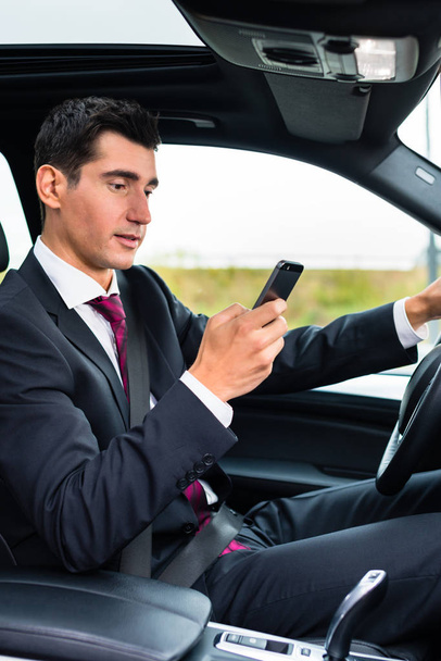 Man texting while driving by car - Фото, зображення