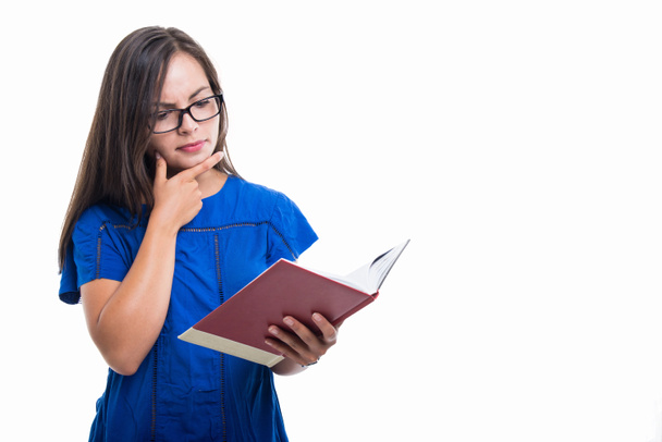 Portrait of student girl holding notebook and thinking - Foto, Imagen