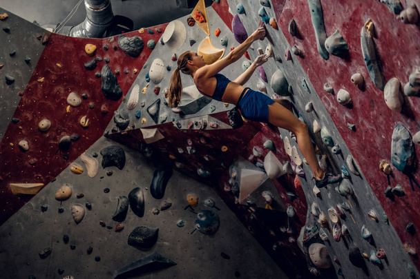 Female climber. Extreme indoor climbing. - Photo, Image
