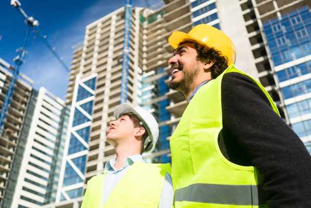 Architects on large construction site giving instructions - Φωτογραφία, εικόνα