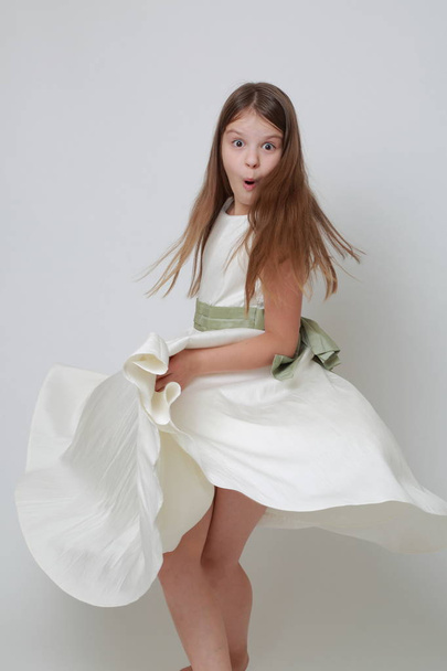 Gorgeous teen girl in a dress posing for a studio portrait - Foto, Imagem