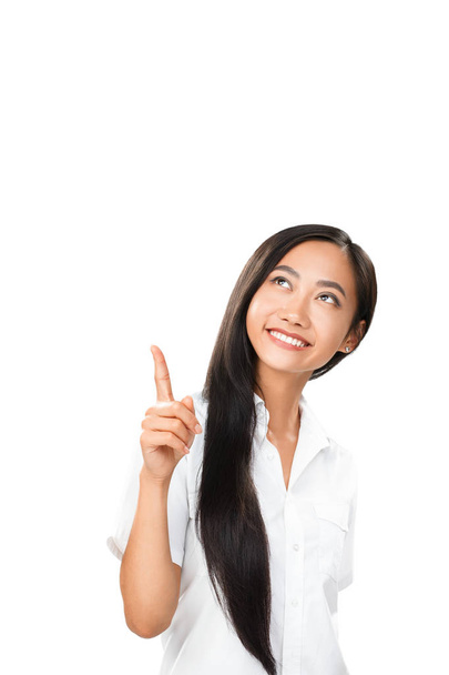 Carefree smiling Asian woman pointing finger up - Fotoğraf, Görsel