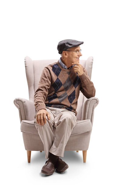 man sitting in an armchair and looking away - Photo, Image