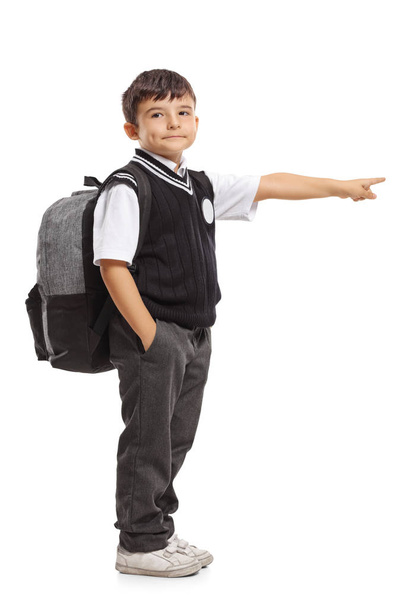 Schoolboy with a backpack pointing - Foto, Bild