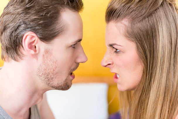 Nuori aviopari, nainen ja mies, raivoissaan taistella tuijottaen
 - Valokuva, kuva