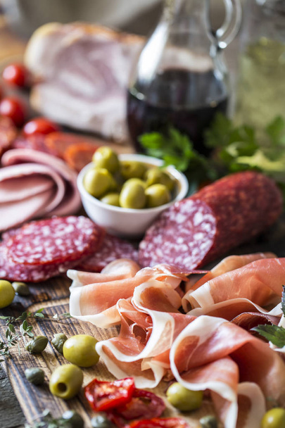 Italian food, prosciutto, grissini, smoked sausage, ham, olives, - Фото, зображення