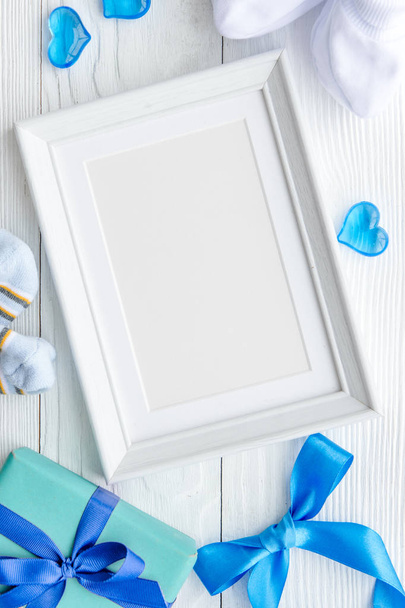 birth of child - blank picture frame on wooden background - Foto, afbeelding