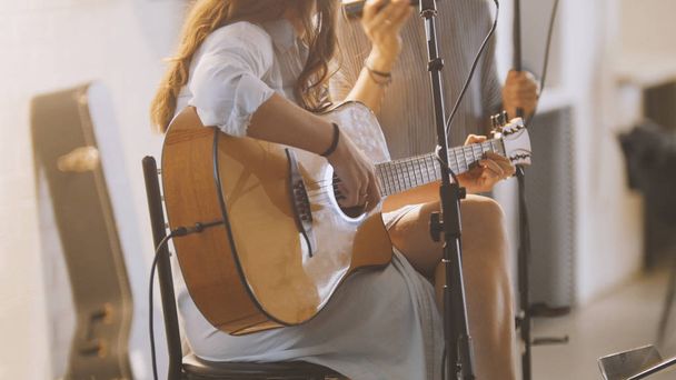 Woman with guitar at stage in loft - Фото, зображення