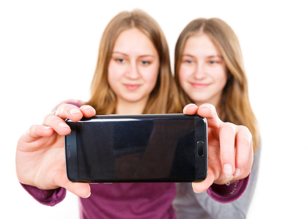 Smiling young sisters taking selfie  - Valokuva, kuva