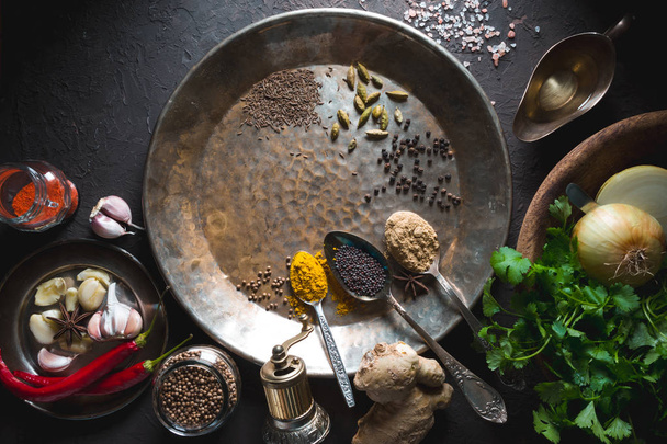 Different spices on the metal plate on the dark background horizontal - 写真・画像