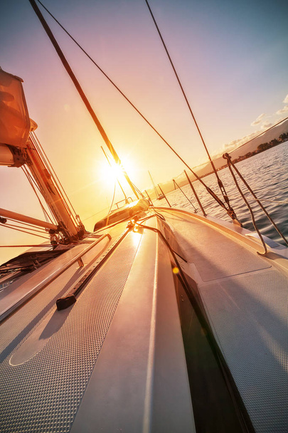 Close-up of yacht sailing against beautiful sunset - Фото, зображення