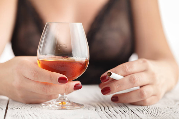 Beautiful woman drinking cognac. - 写真・画像