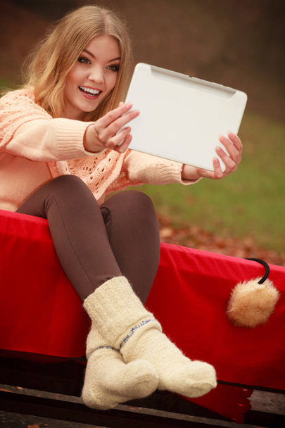 Woman with digital tablet in autumn park - Foto, imagen