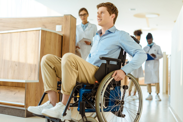 man in wheelchair at hospital corridor - Фото, зображення
