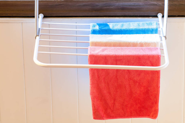 three colored towels on the dryer close-up - Photo, image